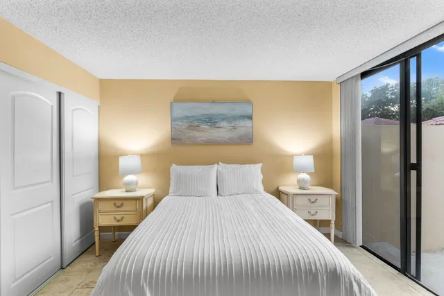 a bedroom with a bed and a large mirror