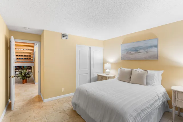 a bedroom with a bed and a painting on the wall