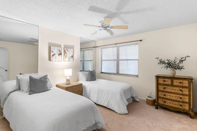 a bedroom with two beds and a window