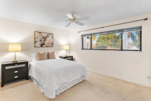 a bedroom with a bed a lamp and a chandelier