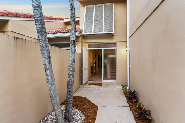 a view of a house with a door and wooden floor