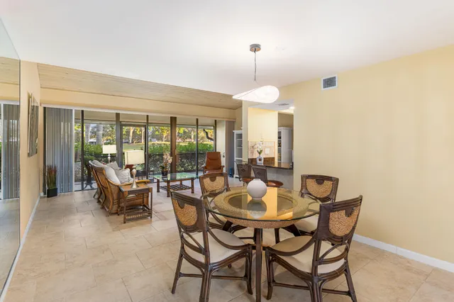 a view of a dining room with furniture and a chandelier