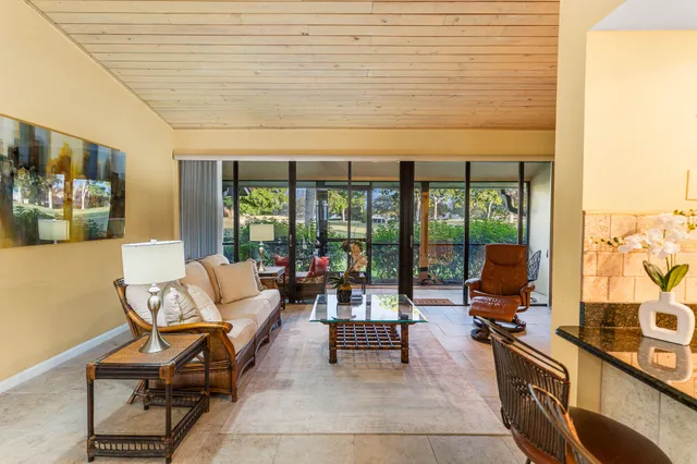 a living room with furniture and large windows