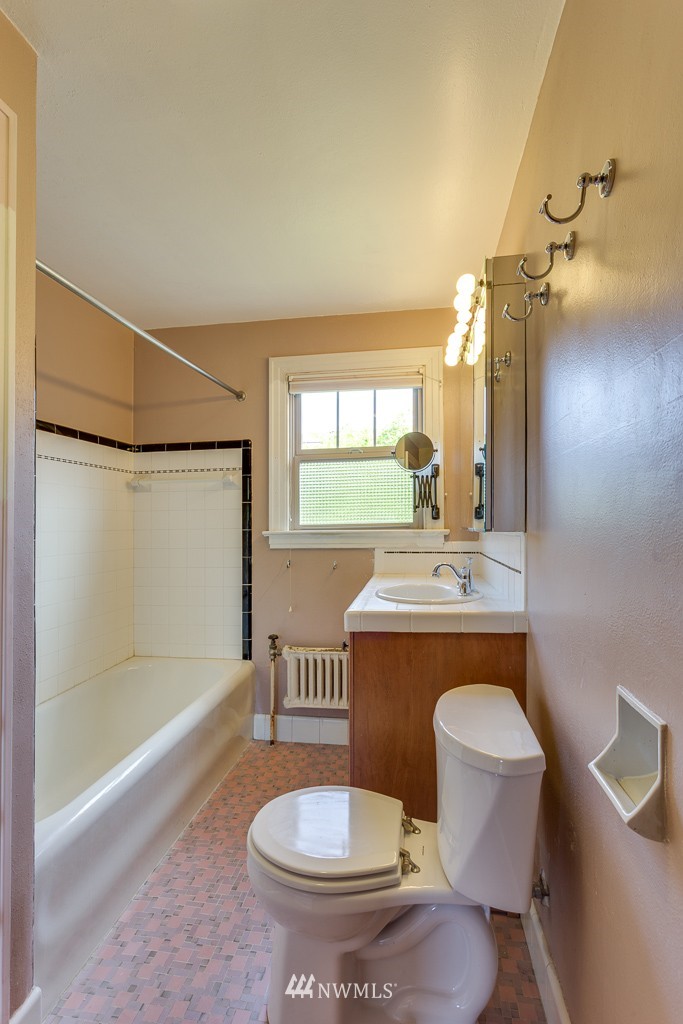 2609 Rucker Avenue Everett, WA 98201 - Photo 11 of 15 a bathroom with a granite countertop sink toilet a mirror and bathtub