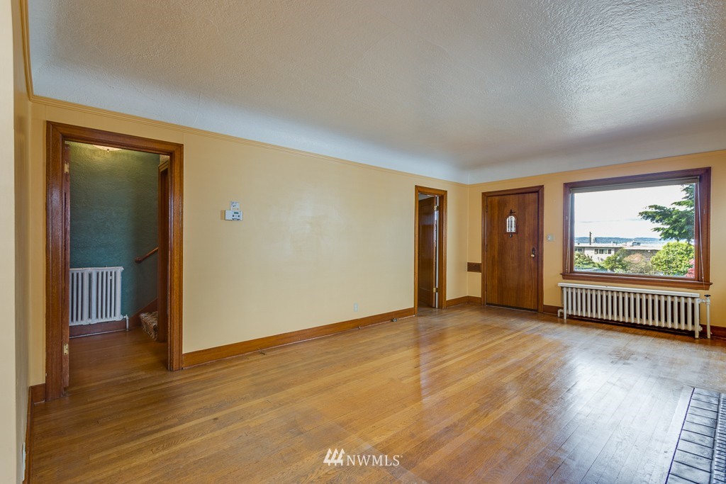 2609 Rucker Avenue Everett, WA 98201 - Photo 4 of 15 an empty room with wooden floor and windows