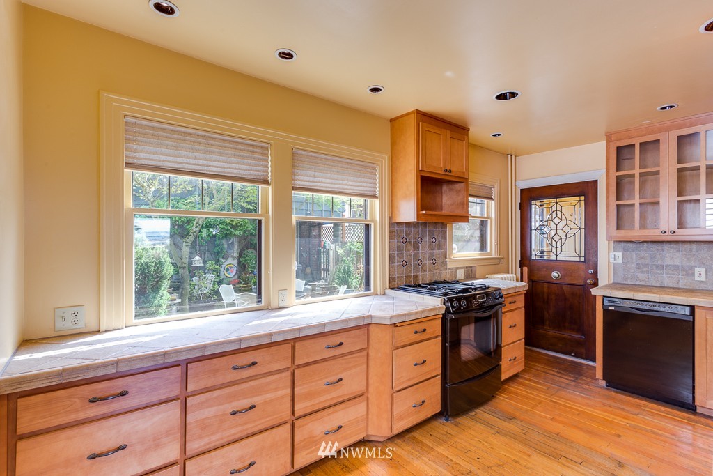 2609 Rucker Avenue Everett, WA 98201 - Photo 6 of 15 a kitchen with stainless steel appliances granite countertop a stove and a sink
