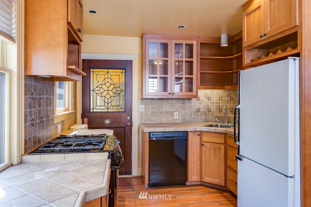 2609 Rucker Avenue Everett, WA 98201 - Photo 7 of 15 a kitchen with stainless steel appliances granite countertop a stove and a refrigerator