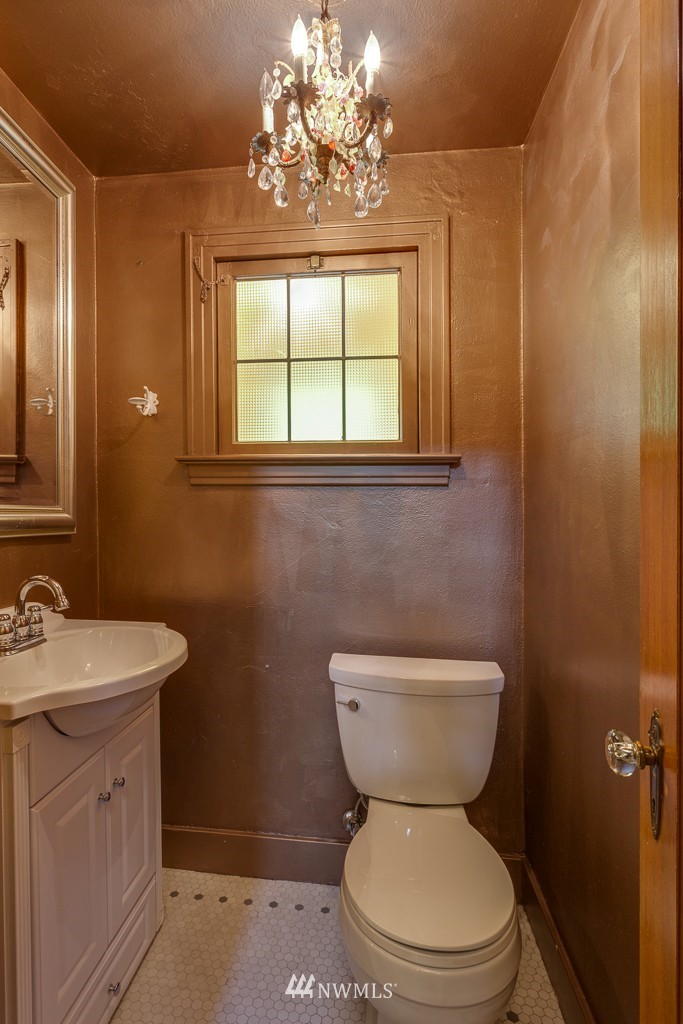 2609 Rucker Avenue Everett, WA 98201 - Photo 9 of 15 a bathroom with a toilet a sink and a mirror