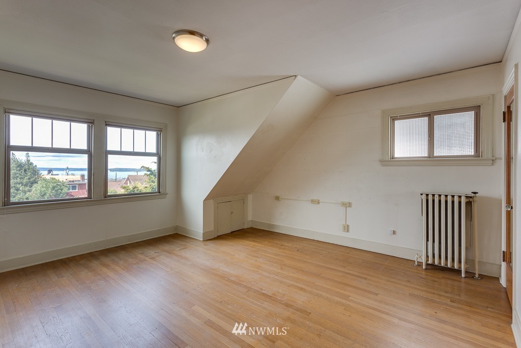 2609 Rucker Avenue Everett, WA 98201 - Photo 10 of 15 an empty room with wooden floor and windows