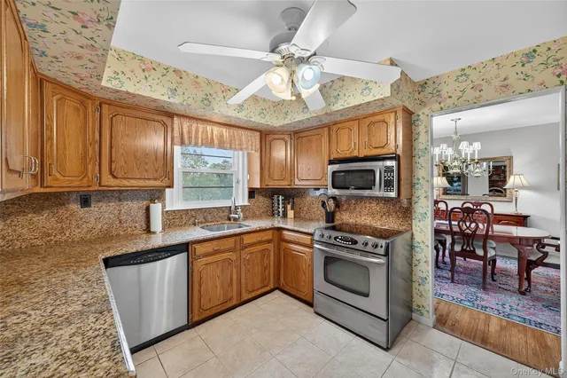 a dining room with furniture a fireplace and large windows