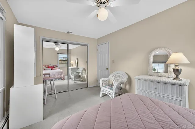 a view of room with wooden floor and fan