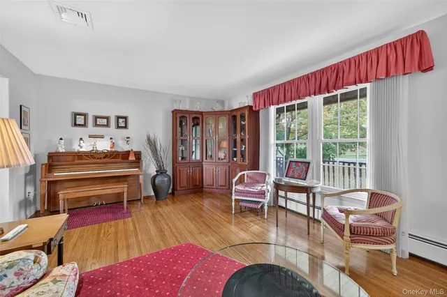 a living room with furniture a rug and a large window