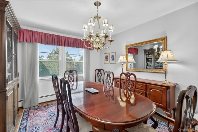 a dining room with furniture a chandelier and window