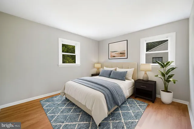 a bedroom with a large bed and a potted plant