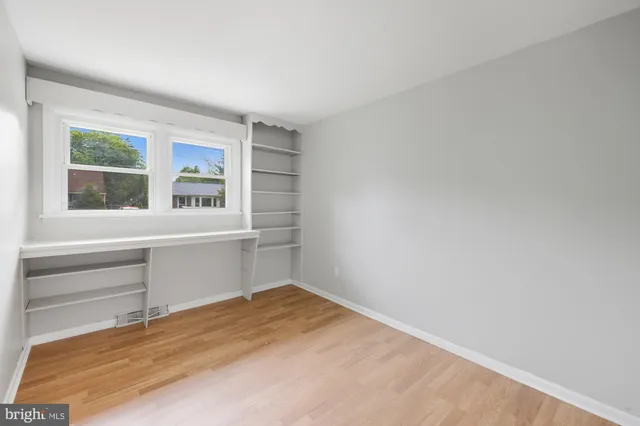 a room with a window and a dresser