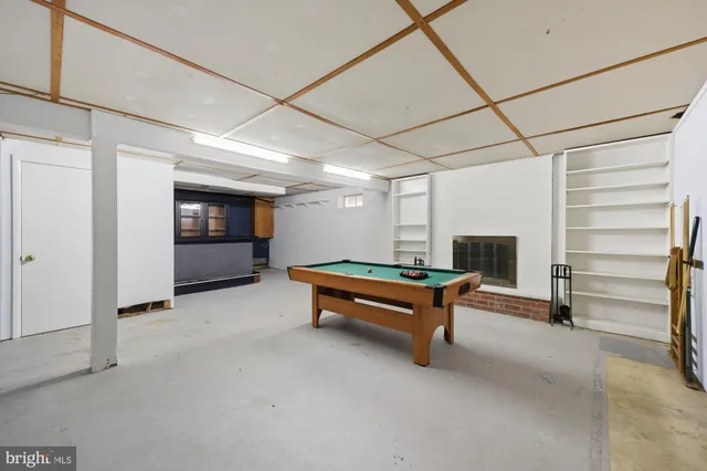 a room with pool table and furniture