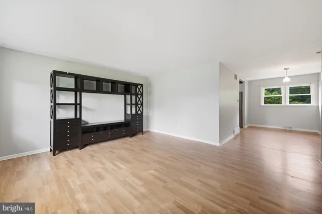 a view of a bedroom with cabinet and mirror