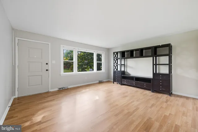 a view of a room with window and hardwood floor