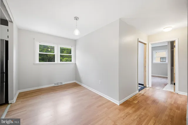 an empty room with windows and closet