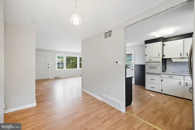 a view of a kitchen with a stove cabinets and wooden floor