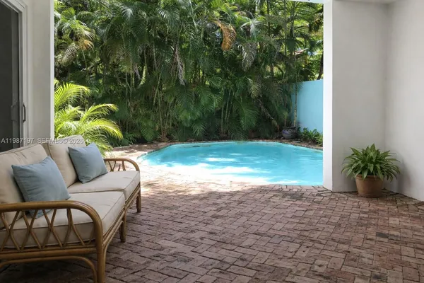 a view of a yard in front of a house with a tree