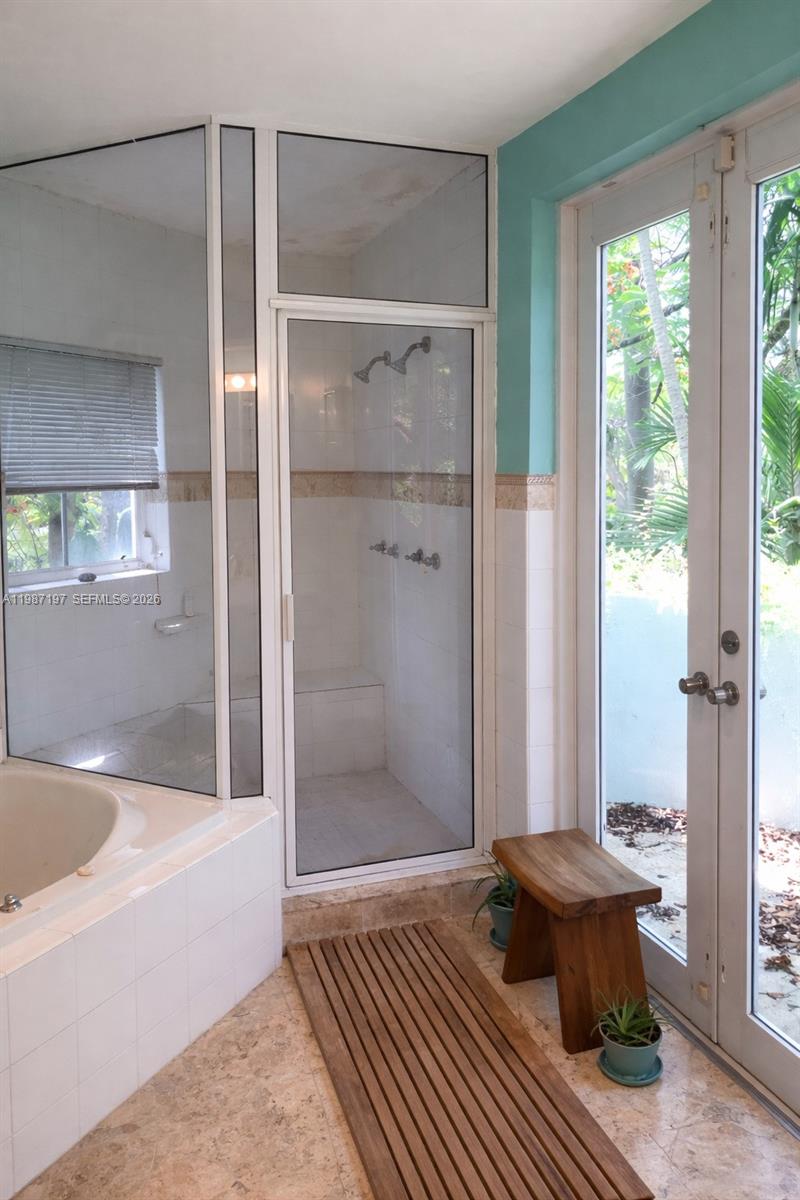 3151 Freeman Street Miami, FL 33133 - Photo 12 of 20 a bathroom with a tub and shower