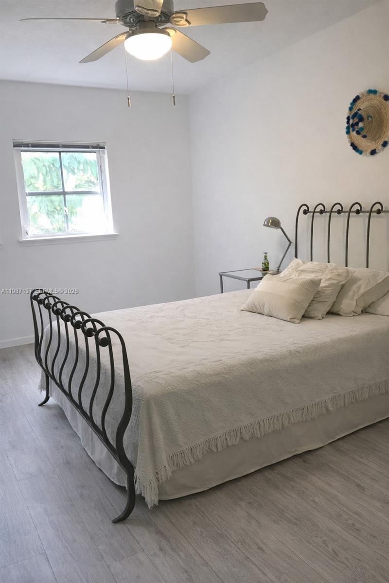 3151 Freeman Street Miami, FL 33133 - Photo 15 of 20 a bedroom with a bed and wooden floor