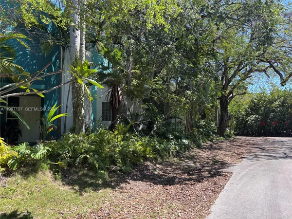 a living room with furniture a flat screen tv and a window