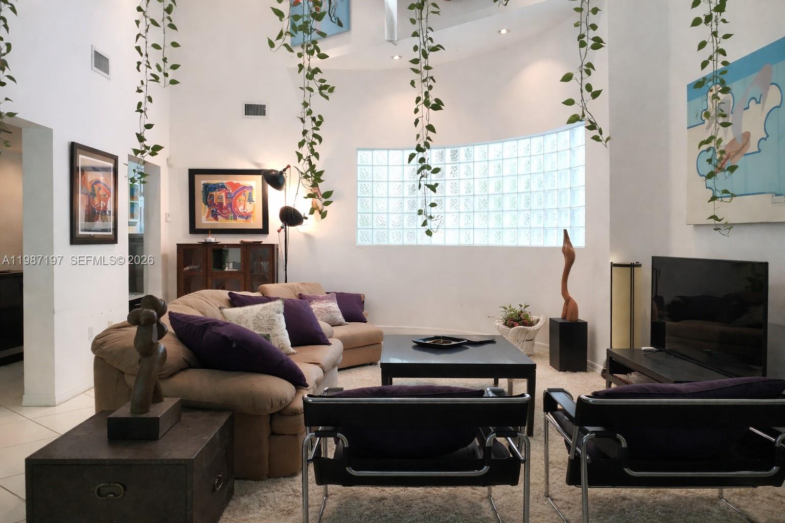 3151 Freeman Street Miami, FL 33133 - Photo 5 of 20 a living room with furniture a flat screen tv and a window