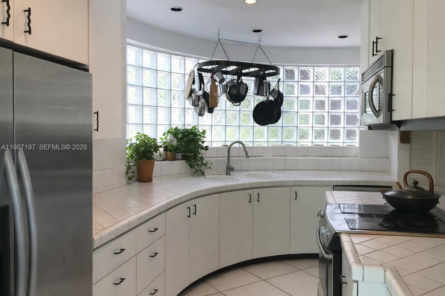 3151 Freeman Street Miami, FL 33133 - Photo 7 of 20 a kitchen with a sink and refrigerator
