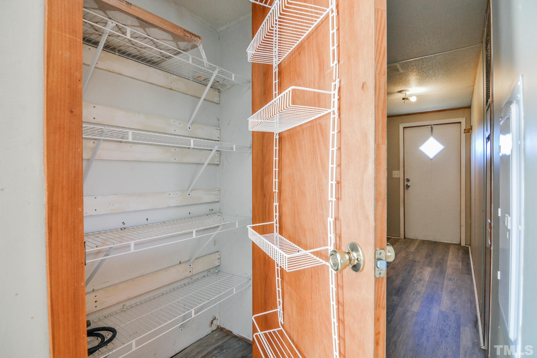 141 Wilson Road Lucama, NC 27851 - Photo 13 of 23 a view of walk in closet with empty racks