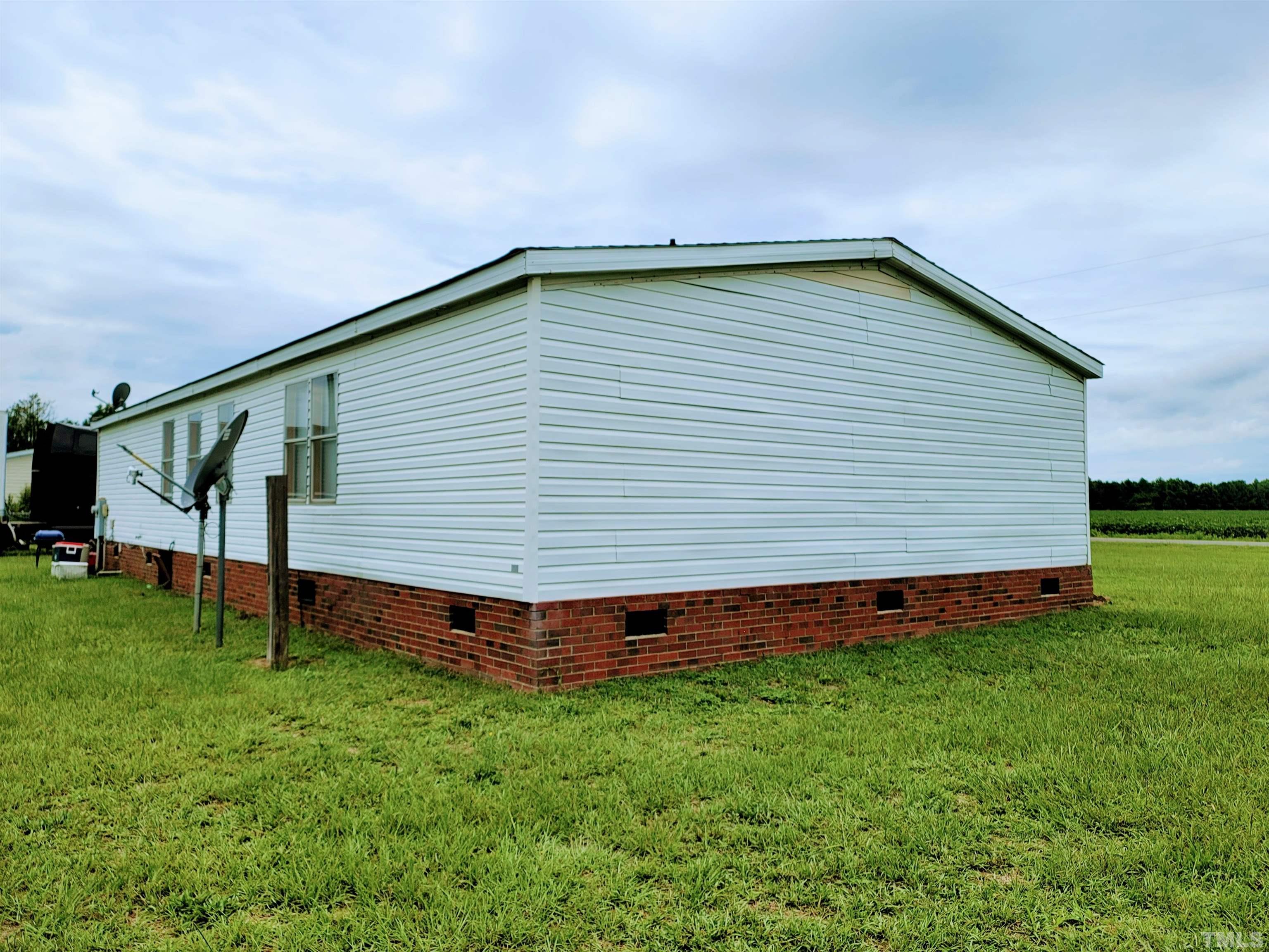 141 Wilson Road Lucama, NC 27851 - Photo 3 of 23 a backyard of a house with lots of green space