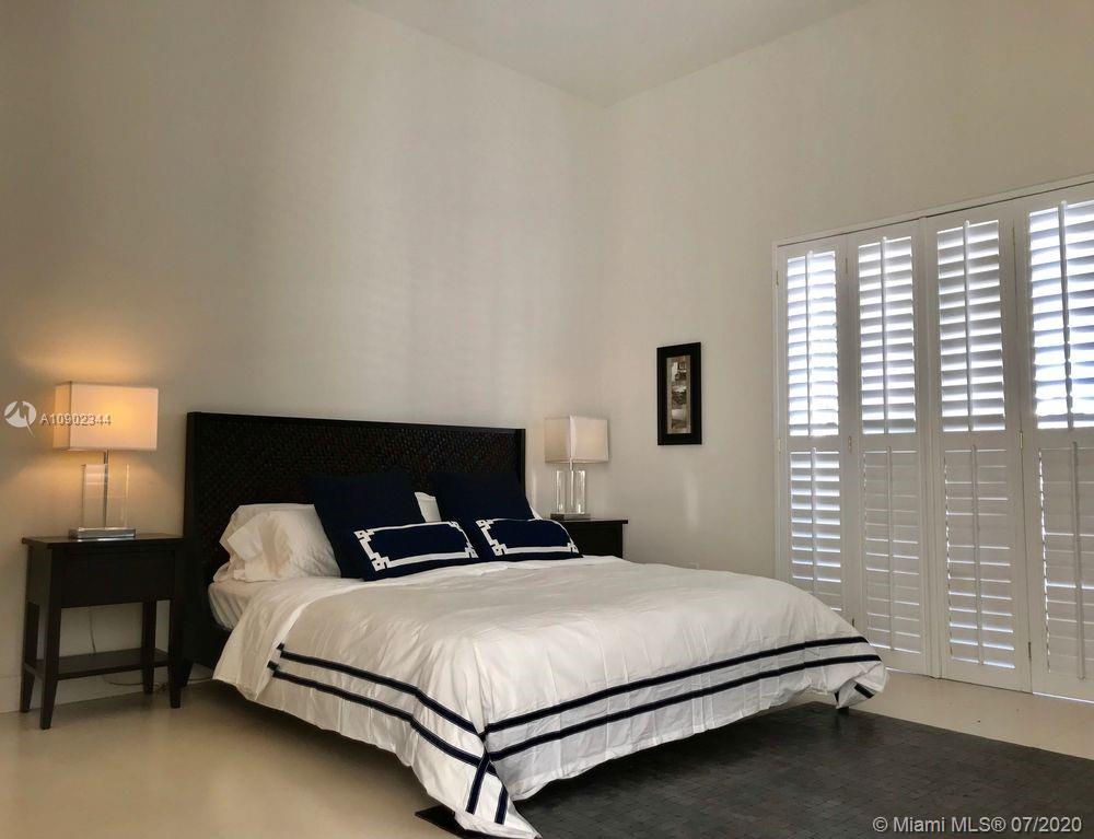 6900 Bimini Bahamas undefined, BH 0000 - Photo 6 of 17 a bedroom with a bed and a lamp next to a window