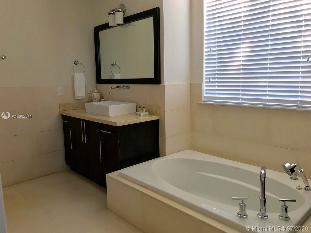 6900 Bimini Bahamas undefined, BH 0000 - Photo 7 of 17 a bathroom with a tub sink and mirror