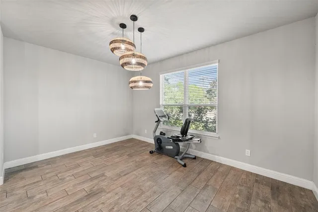 a view of a room with a window and wooden floor