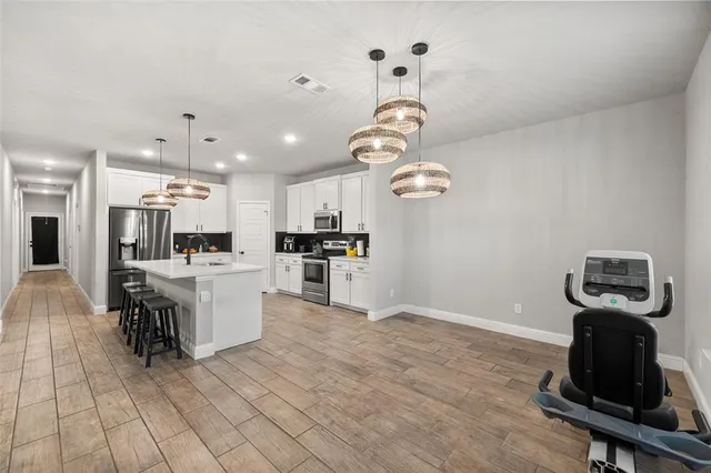 a view of a kitchen with microwave and cabinets