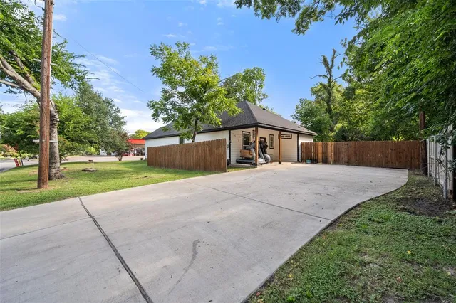 a front view of a house with a yard and a garage
