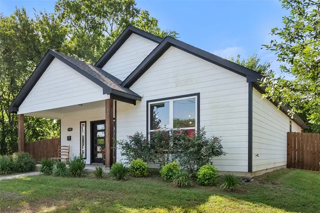 a front view of a house with a yard and porch