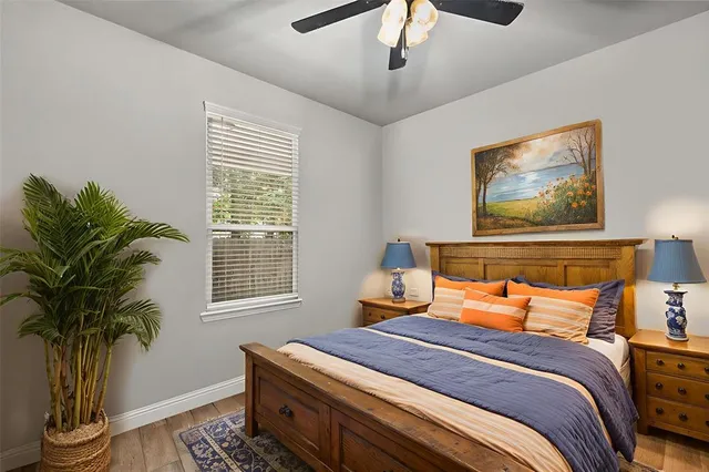 a bedroom with bed and a potted plant