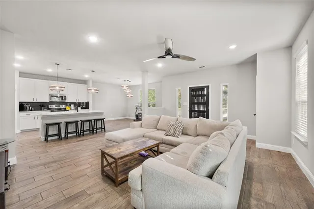 a living room with furniture and kitchen view