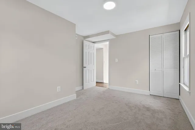 a view of an empty room and closet area