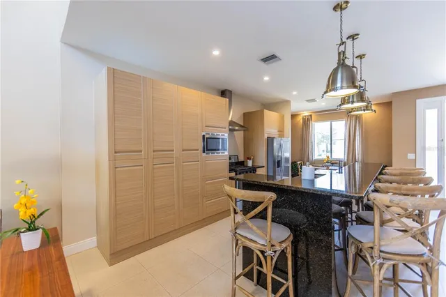 a view of a dining room with furniture and a chandelier