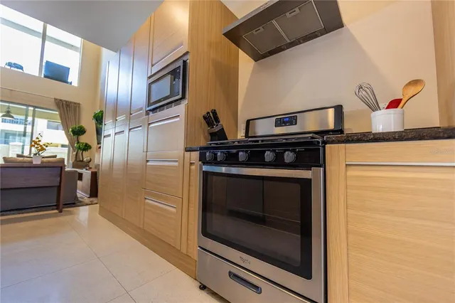 a kitchen with stainless steel appliances granite countertop a stove and a microwave