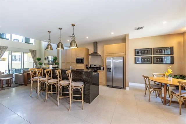 a large kitchen with a table and chairs