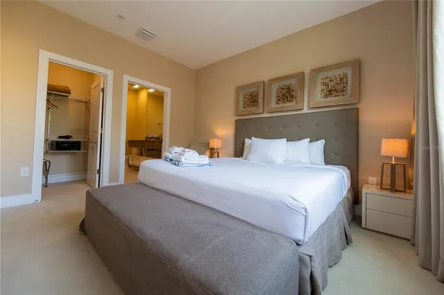 a bedroom with a large bed and a window