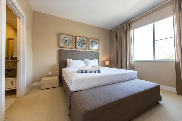 a bedroom with a bed and a large mirror