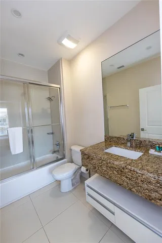 a bedroom with furniture and a large window