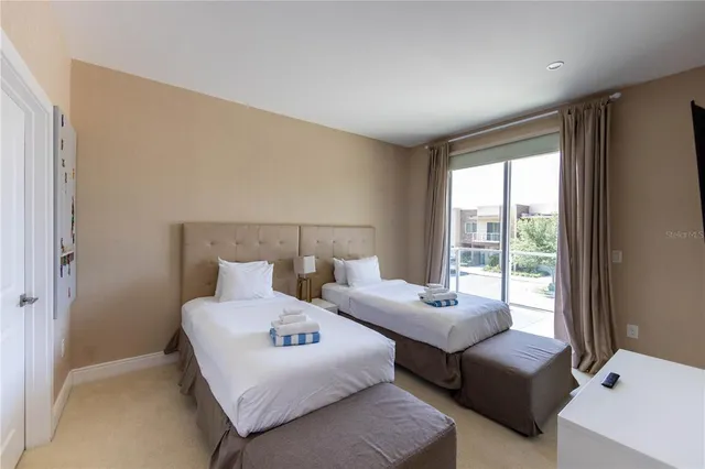 a bedroom with bed and a flat screen tv