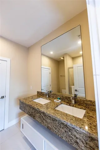 a bathroom with a mirror and next to a wall