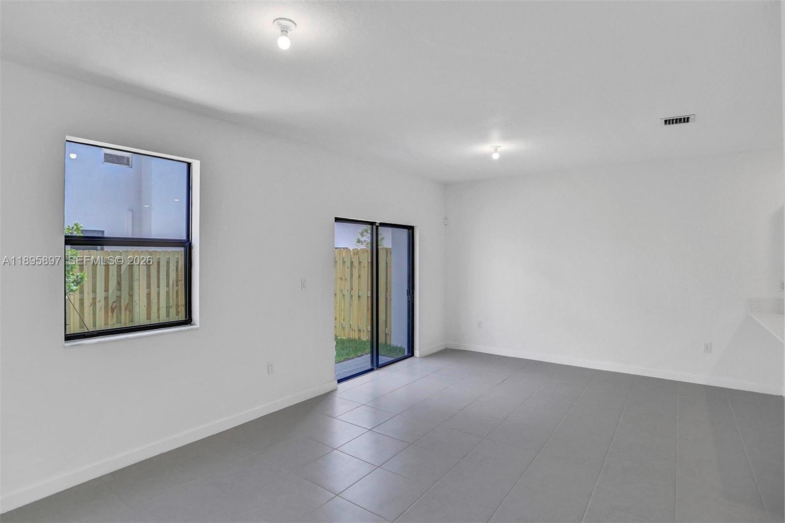 13375 Southwest 287th Street Homestead, FL 33033 - Photo 17 of 44 an empty room with windows and closet
